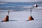 A closeup of two mooring buoys floating in the middle of frozen sea on a sunny spring day