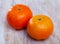 Closeup of two whole ripe organic clementines