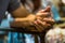 Closeup on two young lovers holding hands at a table, symbol sign sincere feelings, compassion, loved one, say sorry. Reliable