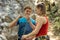 Closeup of two young rock climbers checking equipment.