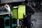 Closeup of uber eats food deliver service person on bicycle with green back pack in city centter