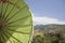 Closeup under antique green asia umbrella on mountain background