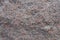 Closeup of uneven surface of pink granite stone