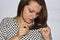 Closeup unhappy frustrated young woman surprised she is losing hair, noticed split ends receding hairline. Human