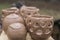 Closeup of unique handmade pots and dishes of clay before firing and reducing process in wood fire kiln.