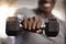 Closeup of unknown african american athlete lifting dumbbell during arm workout in gym. Strong, fit, active black man