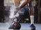 Closeup of unknown african american athlete using powder and chalk on hands before lifting kettlebell in gym. Strong