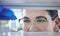 Closeup of unknown caucasian medical scientist wearing glasses and looking at a medicine vial in a laboratory