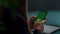 Closeup unrecognizable business woman typing on mobile phone with green screen