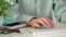 Closeup of unrecognizable female hands typing on wireless keyboard during work on computer in office or at home