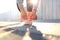 Closeup of unrecognizable sport woman tying sports shoes during evening run outdoors