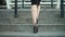 Closeup unrecognized woman legs going upstairs. Female feet walking in shoes
