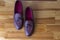 Closeup Upper View of Pair of Traditional Formal Stylish Brown Pebble Grain Tassel Loafer Shoes On Wooden Surface