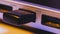 Closeup of USB flash drive inserted into port on the side of a l
