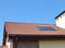 Closeup of Vacuum Solar Water Heating System Rain Gutter on the Red Tiled House Roof