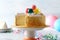 Closeup of vanilla birthday cake colorful balloon topper