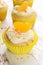 Closeup of vanilla buttercream cupcakes with orange slice