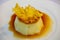 Closeup of a Vanilla flan with caramel with a slice of dried pineapple on top