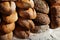 Closeup variety Artisanal bread loaves stacked on table- horizontal