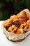 Closeup on variety of sweet baked buns in a basket