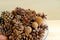 Closeup various types of natural dry pine cones in a glass bowl