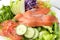 Closeup vegetable salad top with smoked salmon