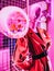 Closeup vertical illustration of a pink mannequin with a red coat and a pink balloon