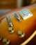 Closeup vertical shot of a brown electronic guitar