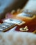 Closeup vertical shot of a brown electronic guitar