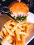 Closeup vertical shot of a burger plate with french fries