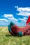 Closeup vertical shot of male crossed legs with warm woolen socks on a countryside lawn