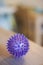 Closeup vertical shot of a purple spike ball on a wooden table