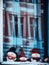 Closeup vertical shot of snowmen soft toys visible through a shop window