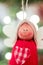 Closeup vertical shot of a wooden doll with knitted clothes with a blurry background