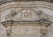 Closeup view of the architrave above the front door of the Church of Purgatory, Matera