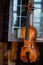 Closeup view of beautiful brown wooden string musical instrument of violin.