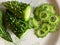 Closeup view of bitter gourd or bitter melon on plate.