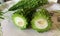 Closeup view of bitter gourd or bitter melon on plate.