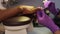 Closeup view of black man hands and female master in protective gloves polishing his nails by file