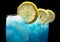 Closeup view of blue lagoon cocktails with ice cubes on black