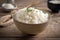 Closeup view bowl of cooked rice showcased on kitchen table