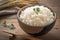 Closeup view bowl of cooked rice showcased on kitchen table