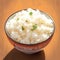 Closeup view bowl of cooked rice showcased on kitchen table