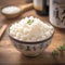 Closeup view bowl of cooked rice showcased on kitchen table