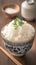 Closeup view bowl of cooked rice showcased on kitchen table