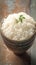 Closeup view bowl of cooked rice showcased on kitchen table