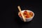 Closeup view of a bowl of noodles with Manchurian and Schezwan sauce isolated on black background