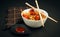 Closeup view of a bowl of noodles with Manchurian and Schezwan sauce isolated on black background