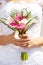 Closeup view of bride holding bouquet of callas