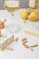 Closeup view of brie and blue cheese with almond, pears, wine glass, bottle and baguette on gray